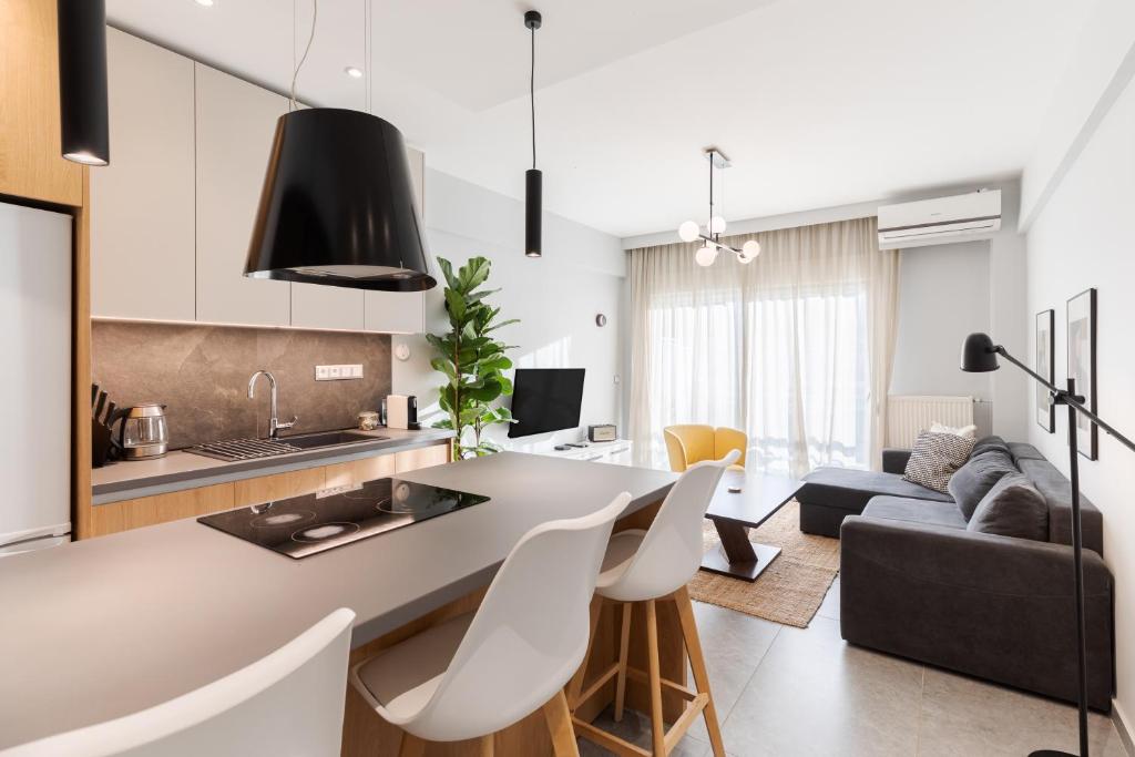 a kitchen and living room with a table and chairs at #Nereids Apts by halu! Apartments in Thessaloniki