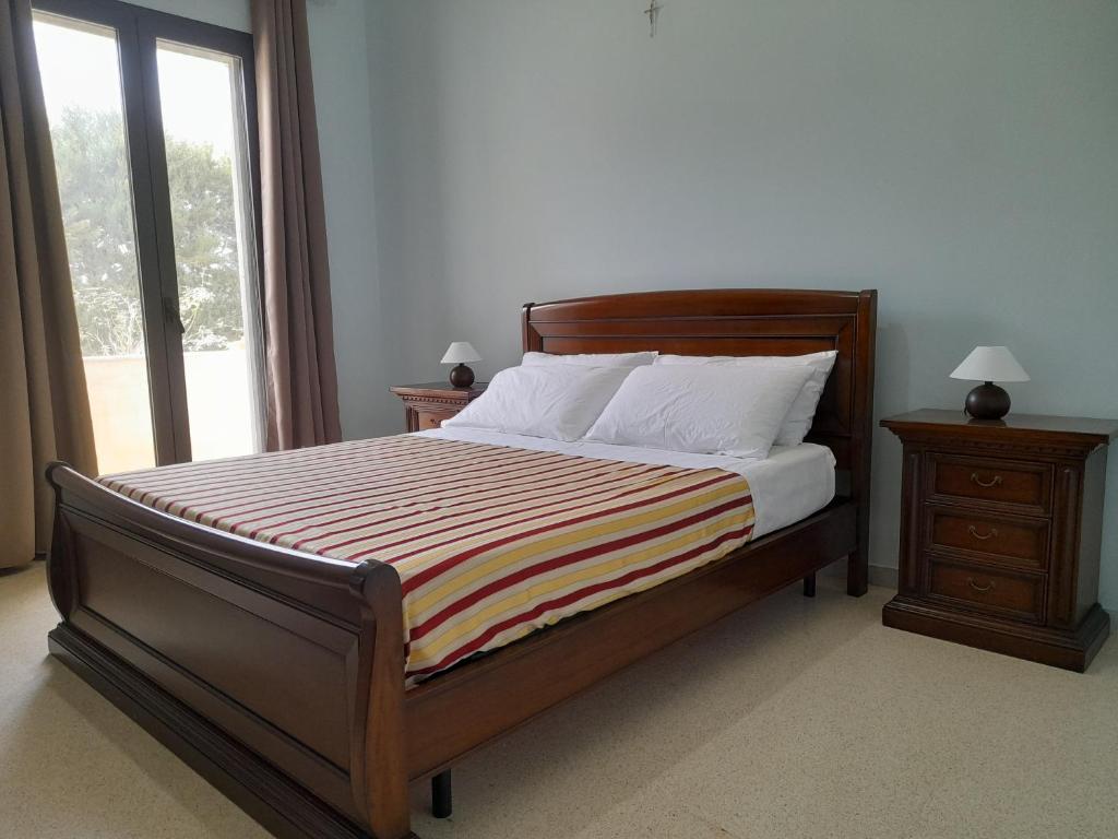 Giường trong phòng chung tại Li tufi Salento casa vacanze Puglia