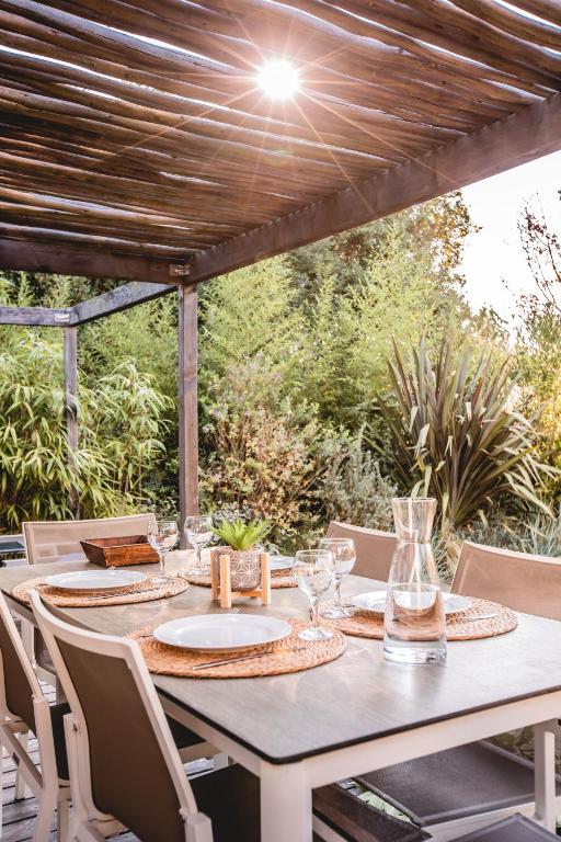 a table and chairs on a patio with a table at Le Phare in Les Portes