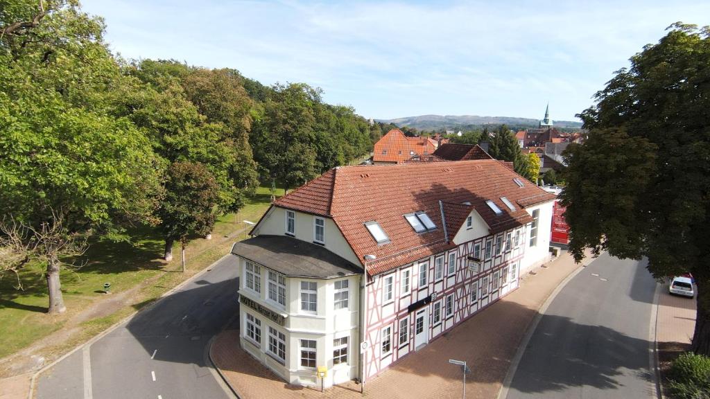 an overhead view of a large white building with a red roof at Hotel garni Harzer Hof in Osterode