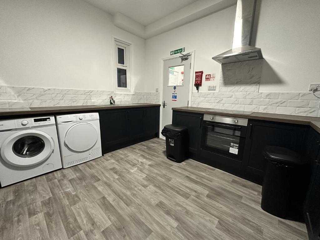 a laundry room with a washer and dryer at Stay Sleep Rest - Gawthorne in Nottingham