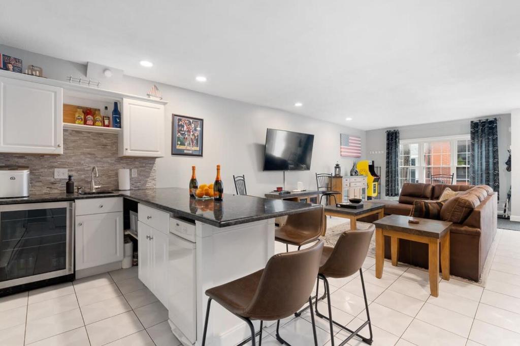 a kitchen and living room with a table and chairs at Heart of Southie - Hot Tub + Walk to Top Bars in Boston
