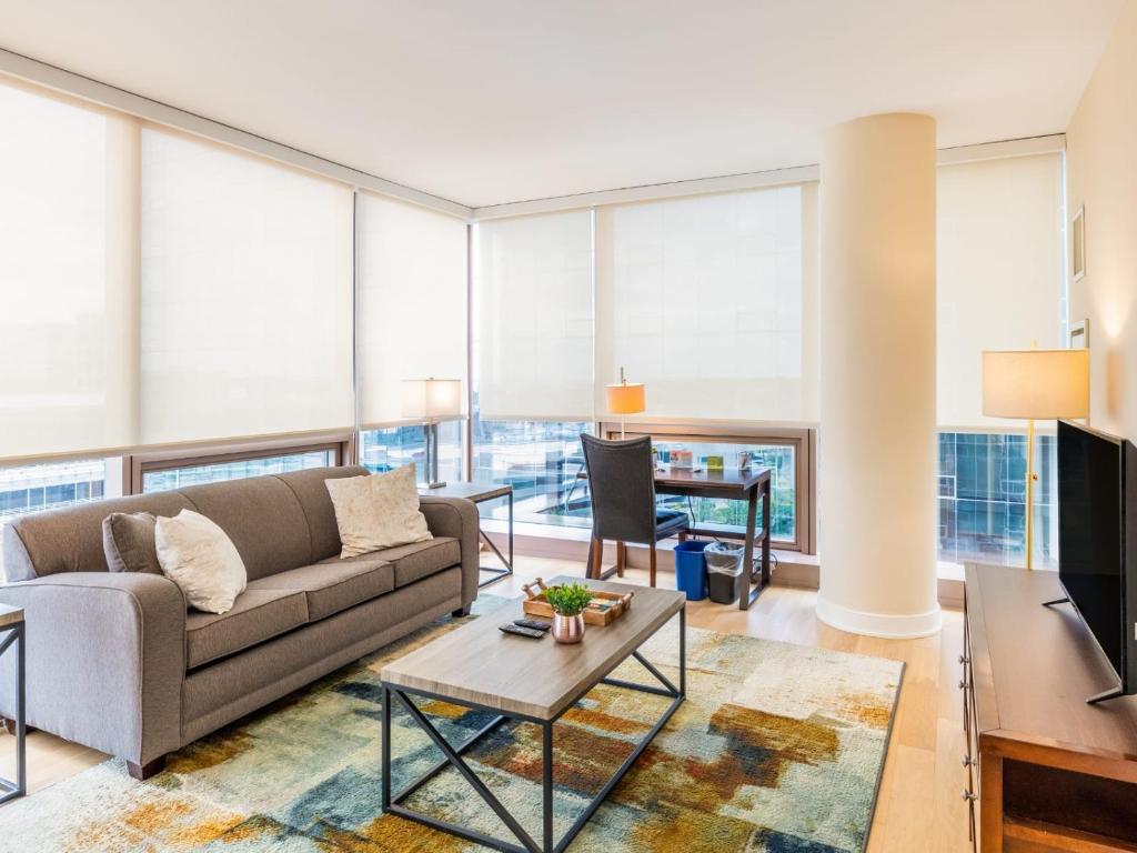 a living room with a couch and a table at Family Friendly Apartment Downtown in Stamford