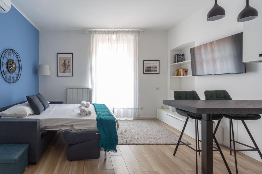 a bedroom with a bed and a desk in a room at Cozy Apartment Porta Venezia in Milan