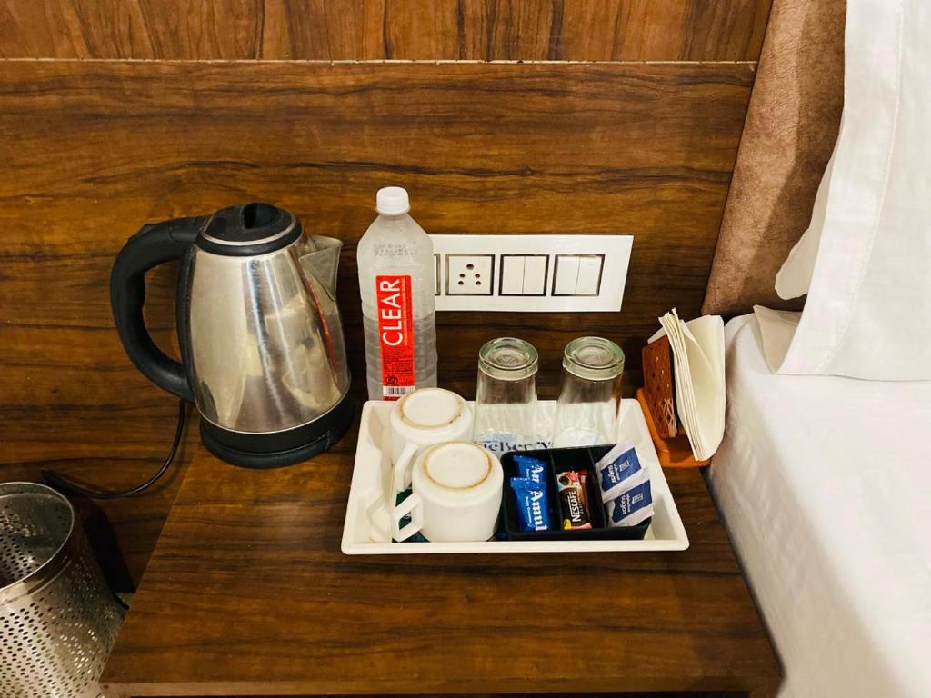 a tray with drinks and a coffee maker on a table at Hotel Jk Residency- 4 min walk from Golden Temple in Amritsar