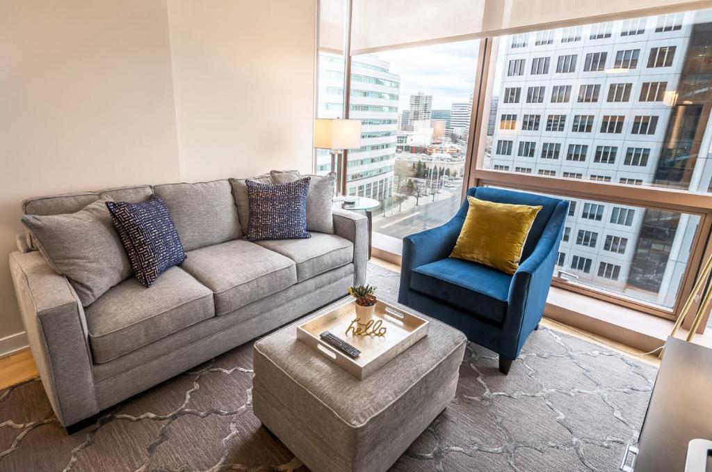 a living room with a couch and a chair at Modern Apart Downtown with Indoor Pool in Stamford