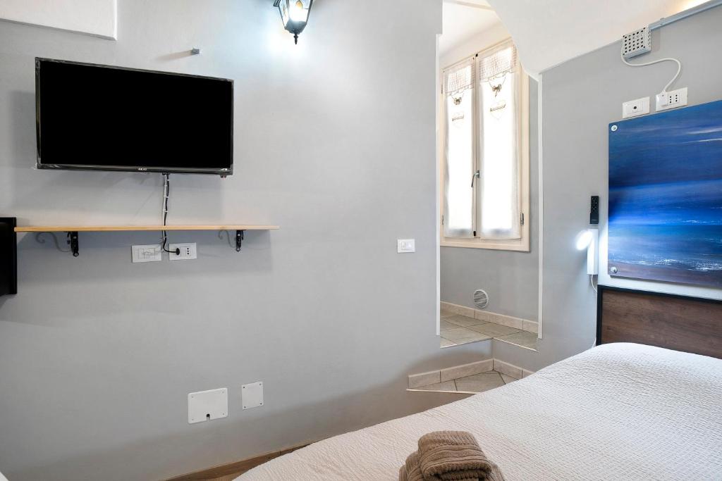 a bedroom with a flat screen tv on a wall at Domus Santa Brigida in Sanremo