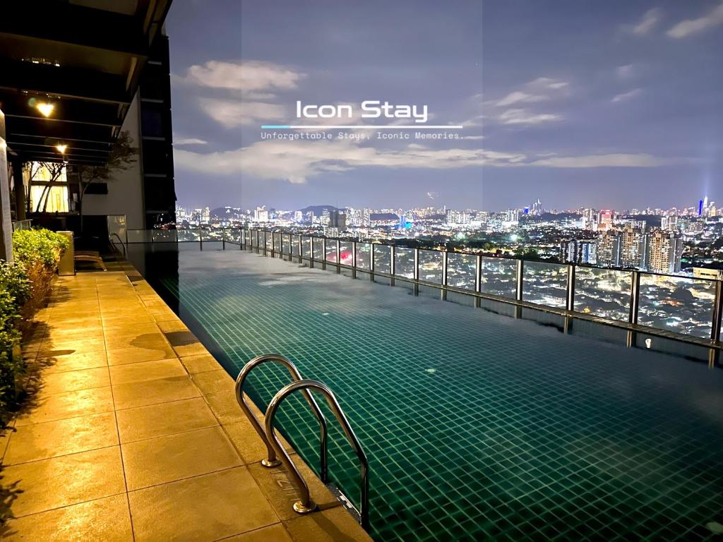 a swimming pool on top of a building with a city skyline at Takuro Homestay in Petaling Jaya