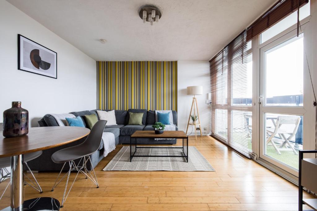 a living room with a couch and a table at The Bermondsey Apartment in London