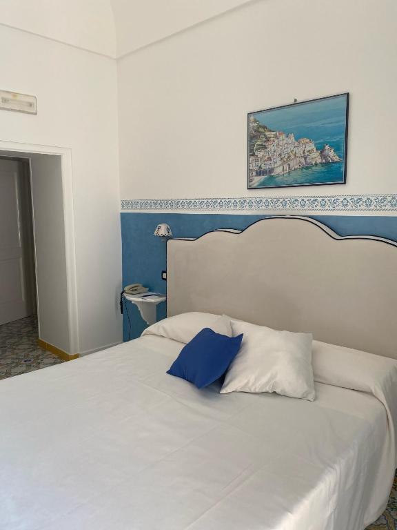Postel nebo postele na pokoji v ubytování Palazzo Talamo