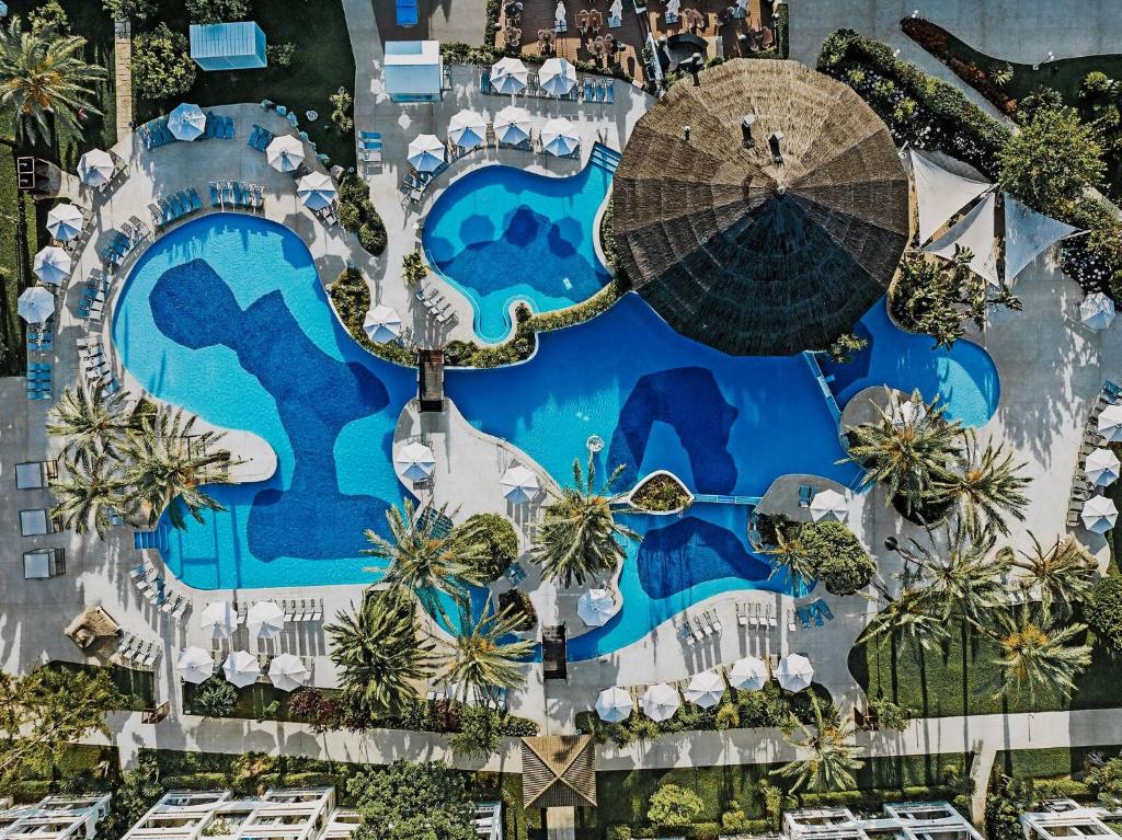 eine Aussicht auf einen Pool in einem Resort in der Unterkunft Prinsotel La Dorada - 4* Sup in Playa de Muro
