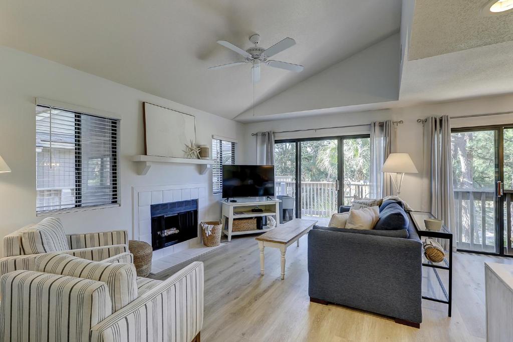 a living room with a couch and a fireplace at Beachwalk 200 in Hilton Head Island