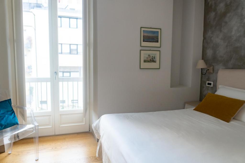 Postel nebo postele na pokoji v ubytování XX SETTEMBRE Urban Relais