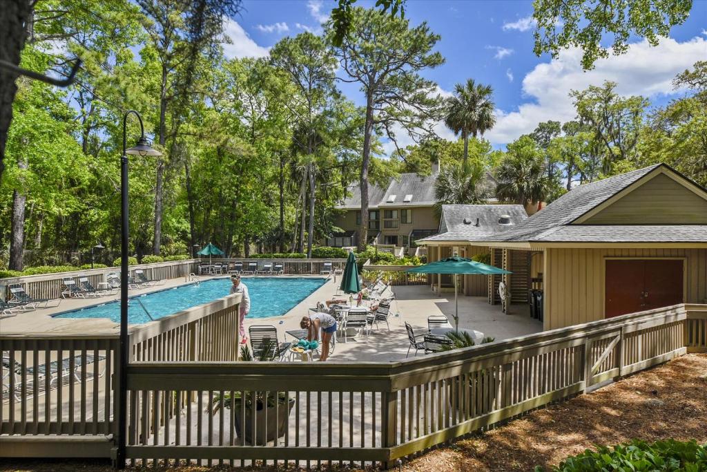 a deck with a pool and a house at Beachwalk 150 in Hilton Head Island