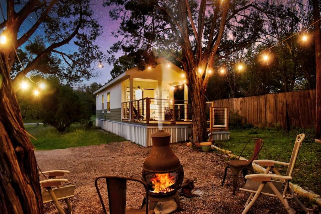 a house with a fire pit in front of it at Lone Star Tiny Home - 15 minutes to downtown in Austin
