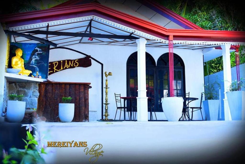 a patio with a table and chairs and a restaurant at Mereiyans Village Villa in Ampara