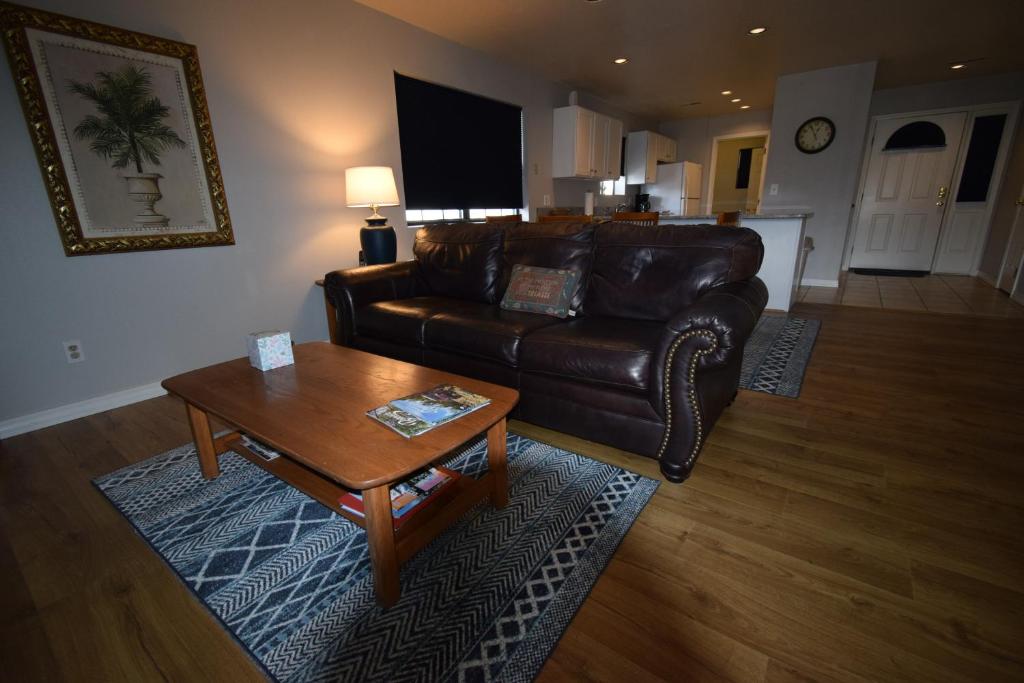 a living room with a leather couch and a coffee table at Grant's Condo in The Greens in Branson