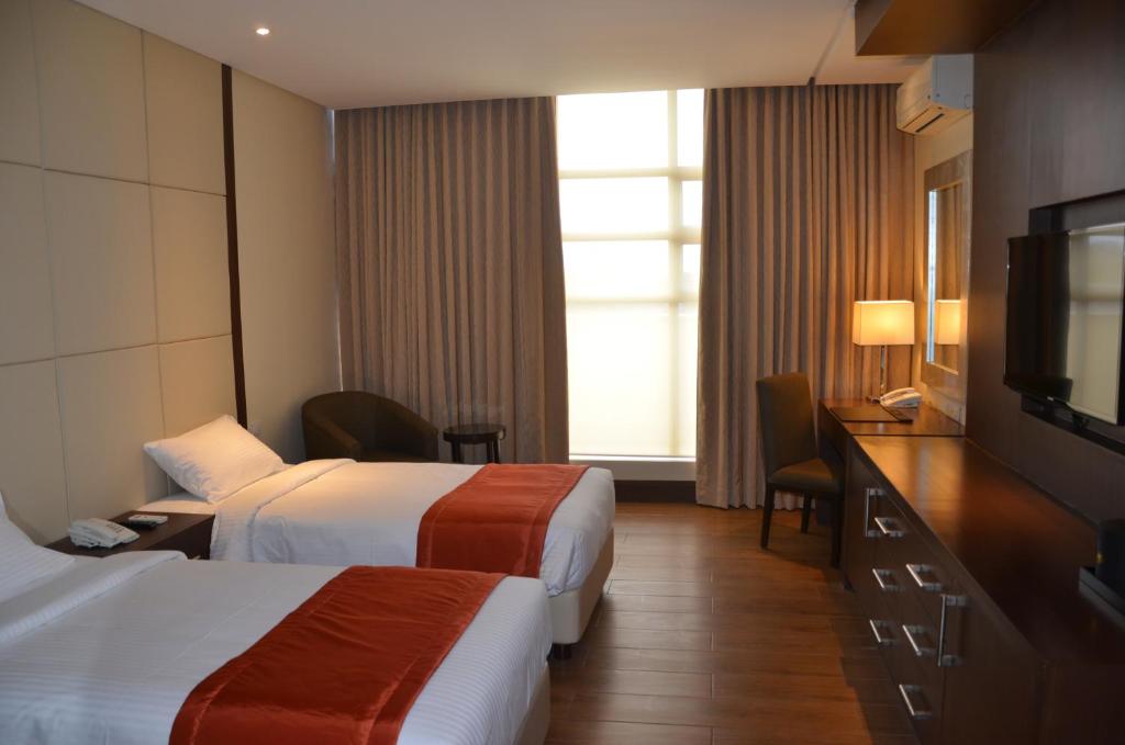 Postel nebo postele na pokoji v ubytování Hotel Monticello Tagaytay