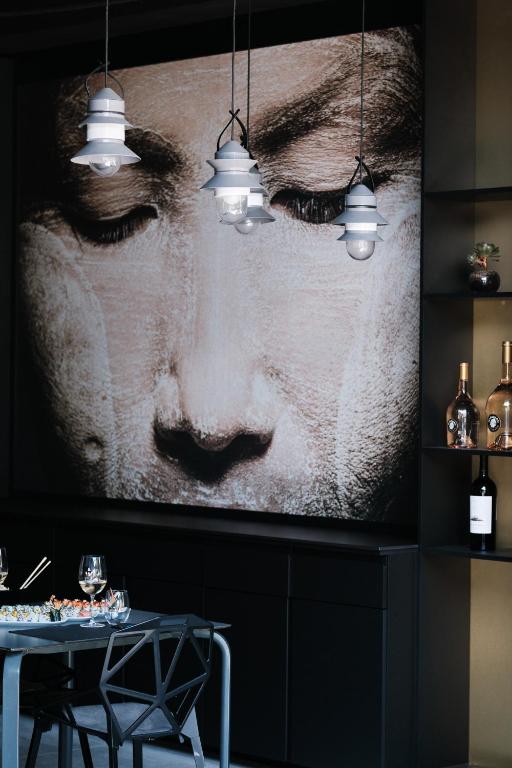 a large picture of a face on a wall with lights at Prinsotel La Dorada & Spa in Playa de Muro