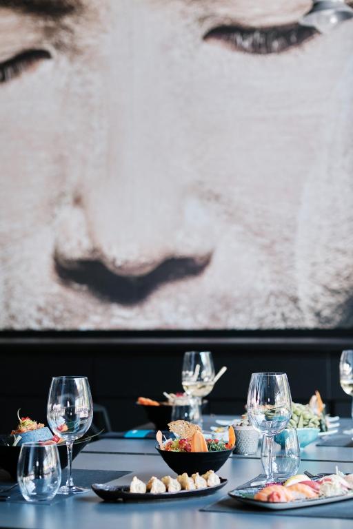 a table with plates of food and wine glasses at Prinsotel La Dorada & Spa in Playa de Muro