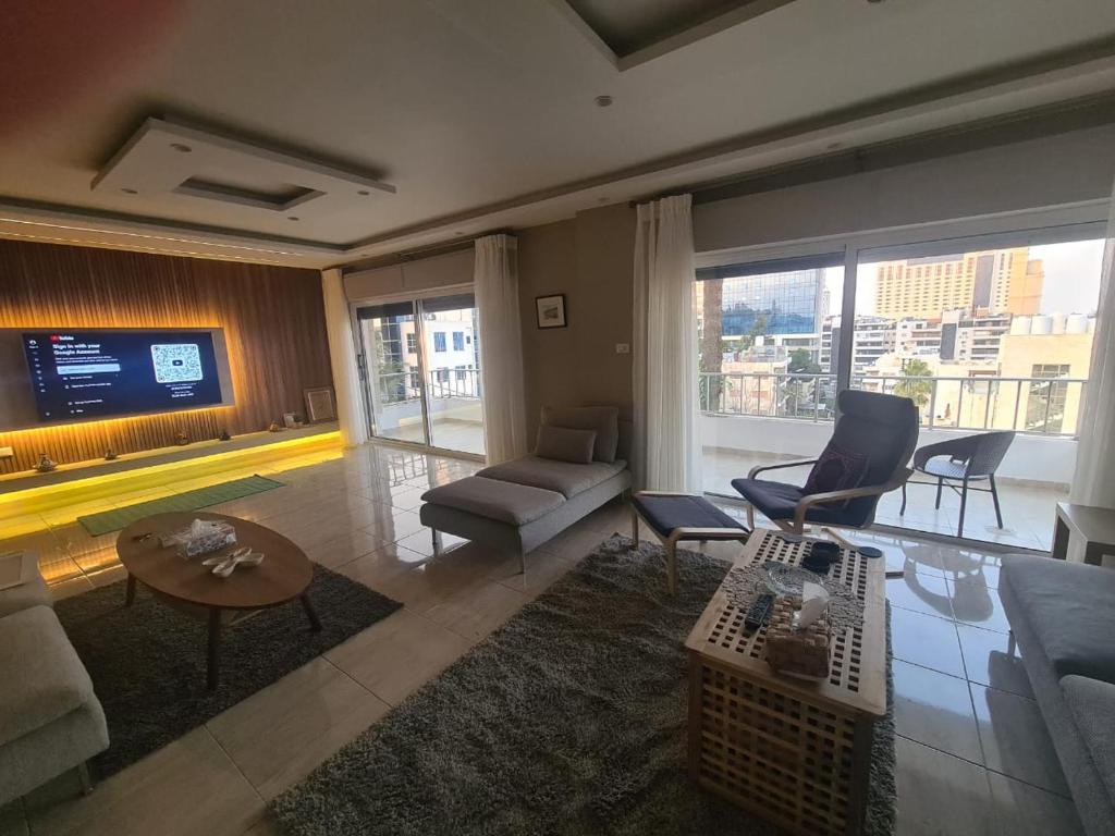 a living room with a couch and a tv at Amman's most prestigious in Amman