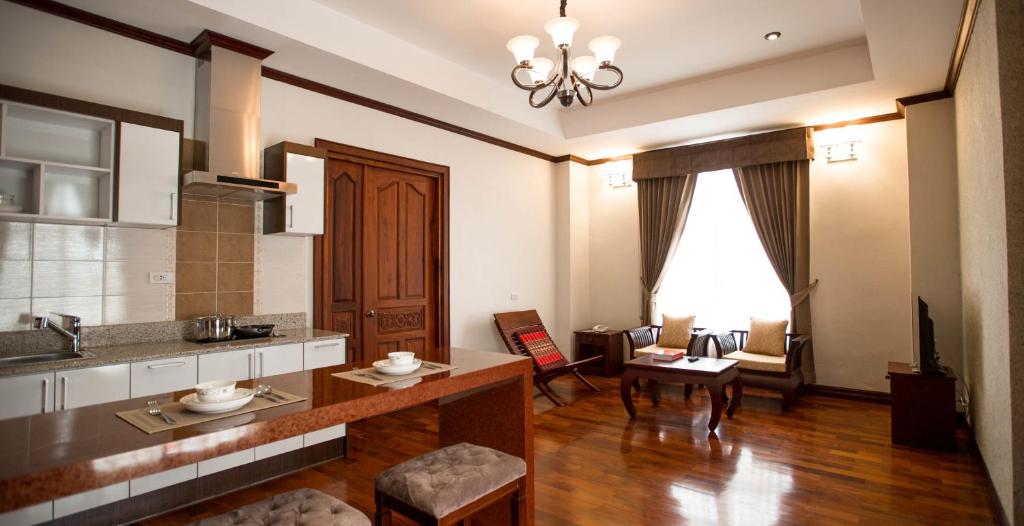 a living room with a kitchen and a dining room at Capitol Residence in Vientiane