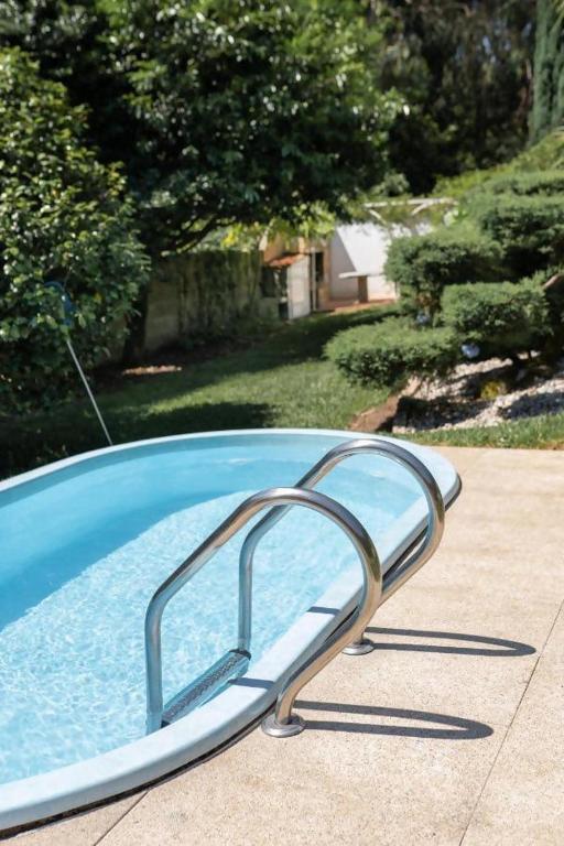 a swimming pool with a slide in a yard at Casa Costaneira in Boiro