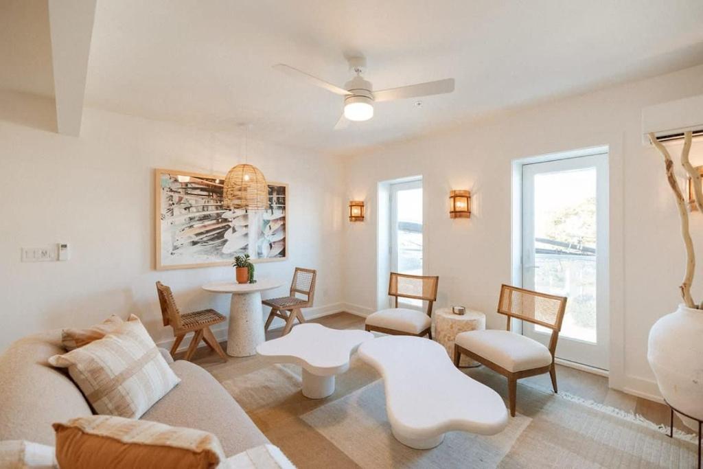 a living room with a couch and a table and chairs at The Oceanic at The Tarrymore in Wrightsville Beach