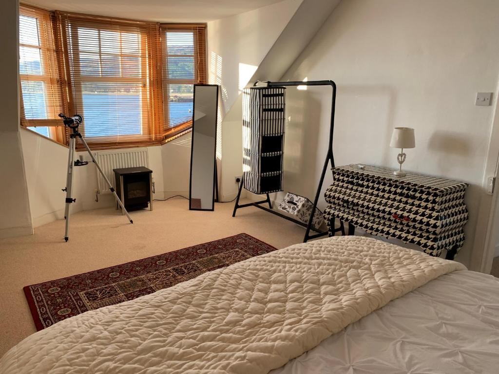 a bedroom with a bed and a tripod and a camera at Sandbankhouse Campbeltown in Campbeltown