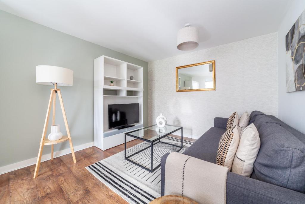 a living room with a couch and a table at The Whitecross Street Apartment in London