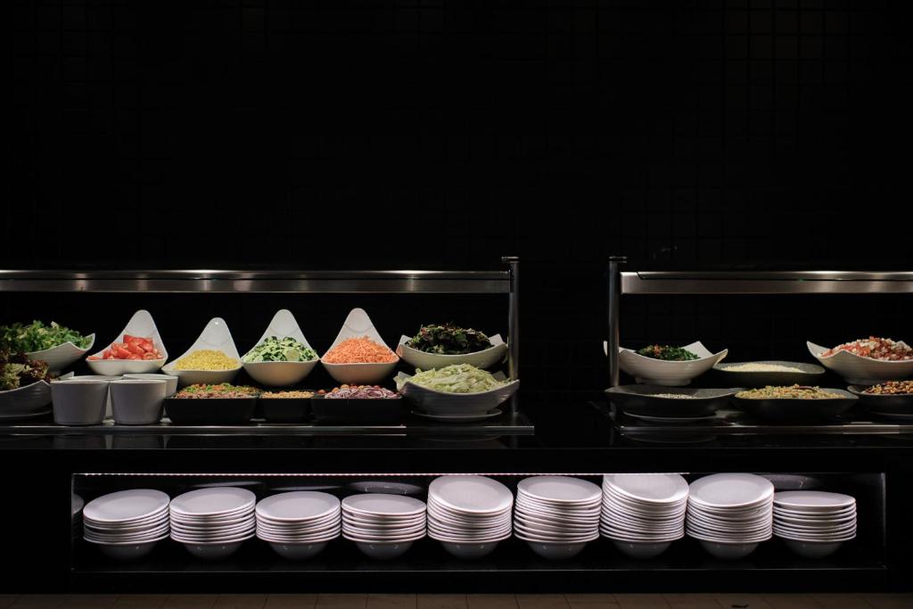 a buffet of food with bowls and plates of food at Prinsotel La Dorada & Spa in Playa de Muro