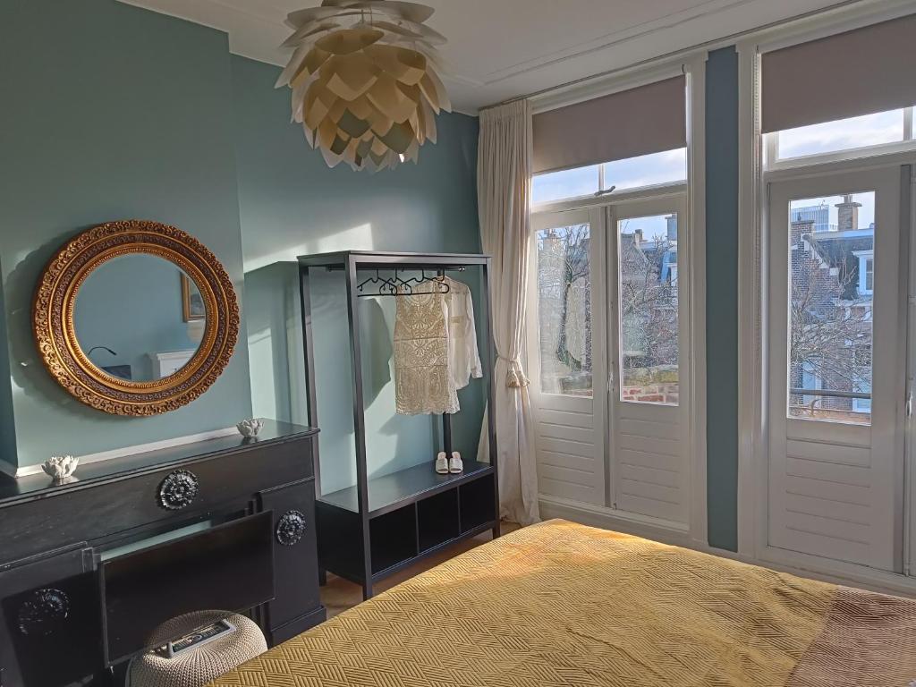 a bedroom with a mirror and a dresser at Luxurious top apartment near beach, musea & Keukenhof in The Hague