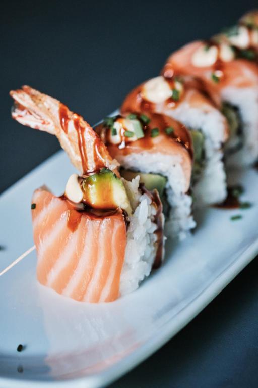 a plate with sushi and rice on a table at Prinsotel La Dorada & Spa in Playa de Muro