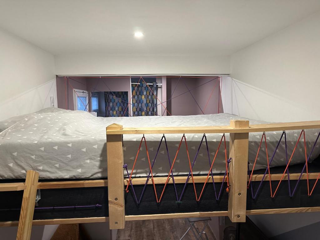 a bunk bed in a room with a bed frame at La Tiny : Adorable petit studio &#47;parking gratuit. in Angoulême