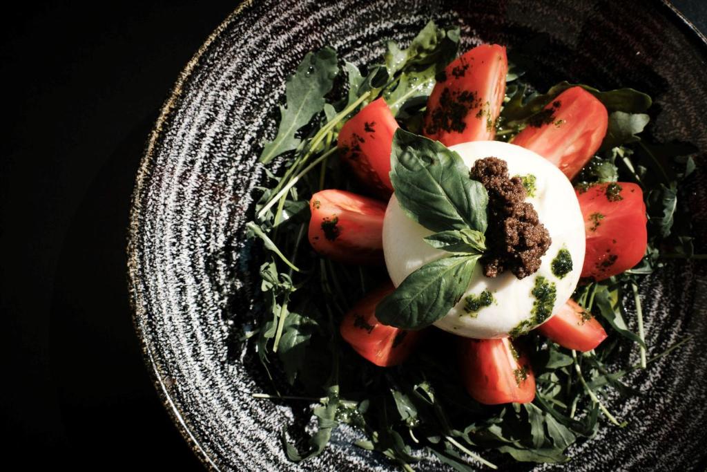 a plate with a salad with an egg on it at Prinsotel La Dorada & Spa in Playa de Muro