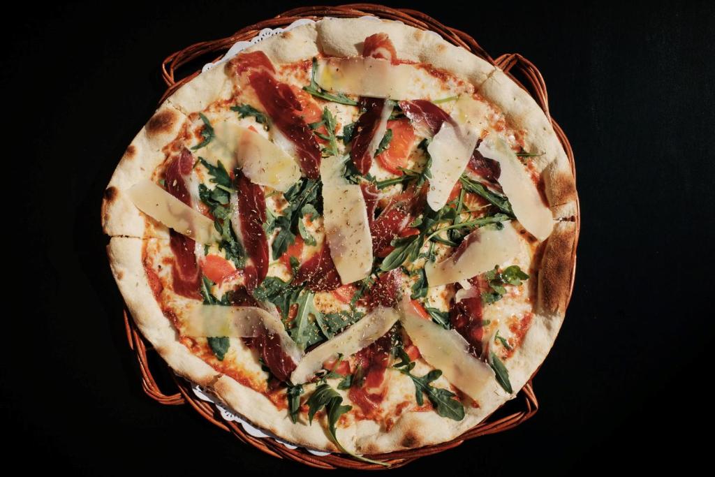 a pizza sitting in a basket on a table at Prinsotel La Dorada & Spa in Playa de Muro