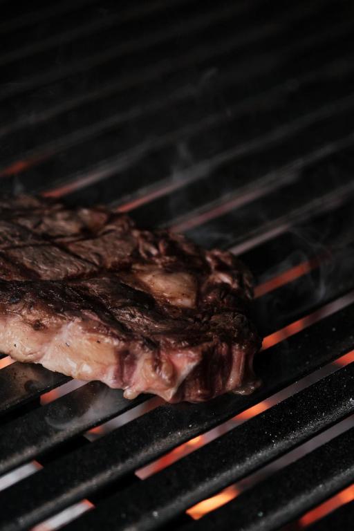 a piece of meat cooking on a grill at Prinsotel La Dorada & Spa in Playa de Muro