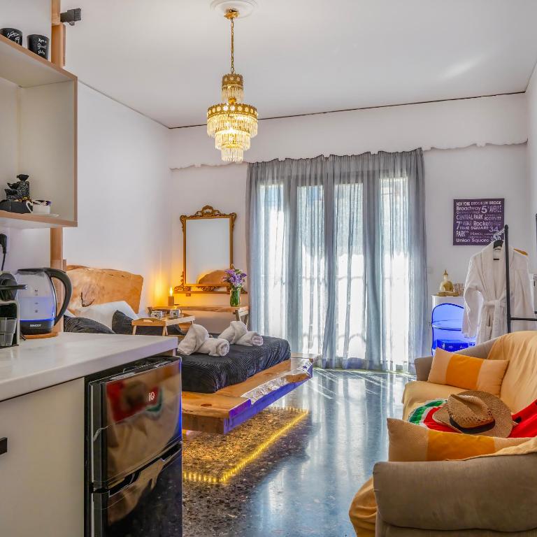 a kitchen and living room with a floor in the middle at Sunny Palm Room Crete in Rethymno