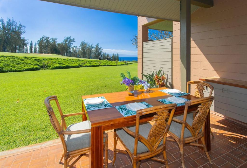 a wooden table with four chairs on a patio at 2511 Ridge in Kahana