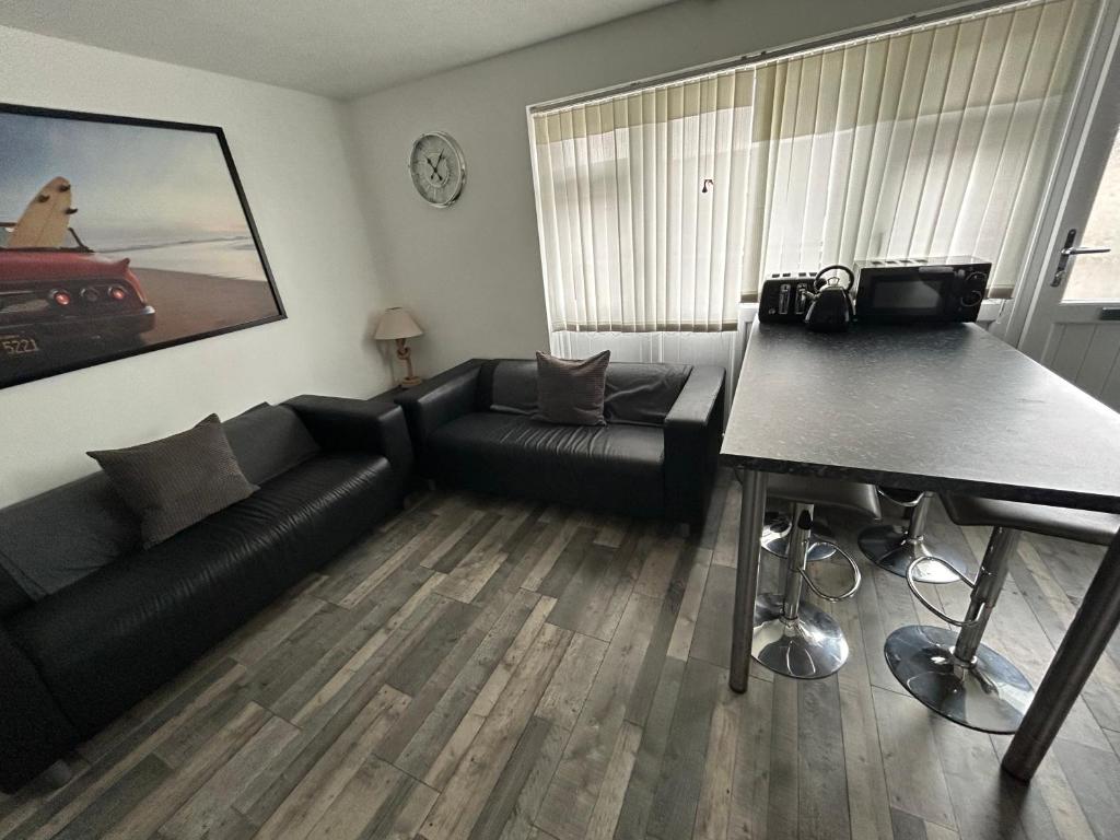 a living room with a couch and a table at 1st Floor family apartment Hillview in Brean