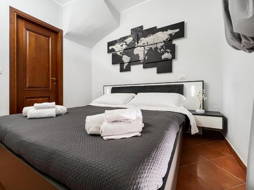 a bedroom with a large bed with towels on it at Coastal Serenity - 300mt from the Sea - Netflix in Fiumicino