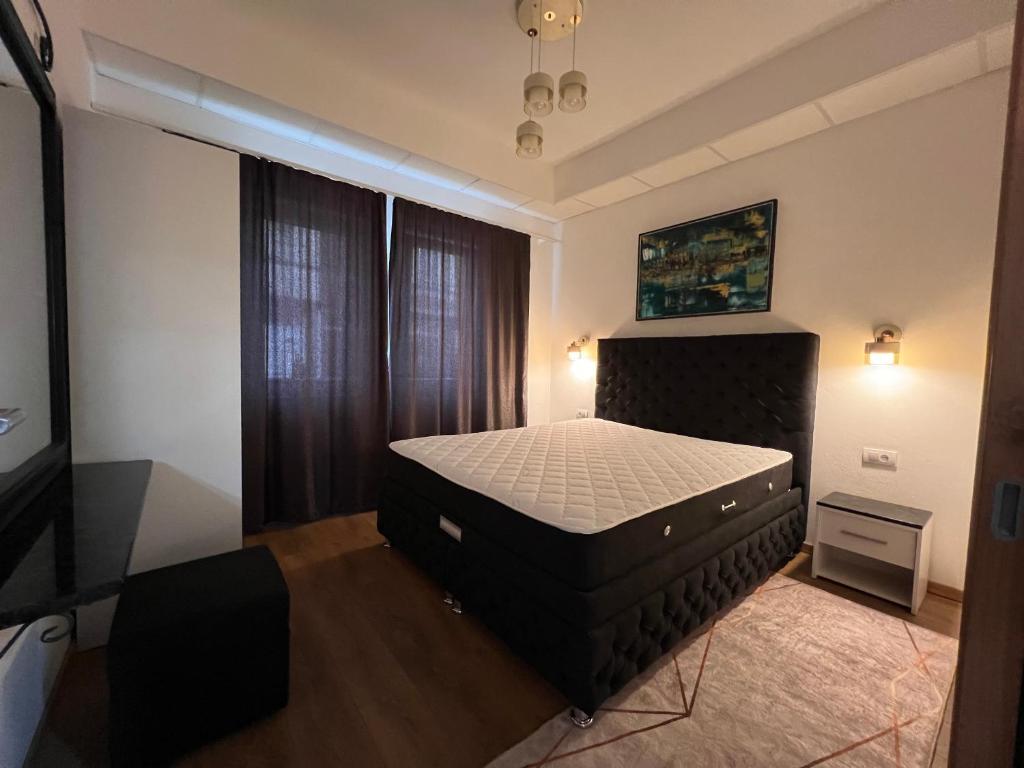 a bedroom with a large bed in a room at Old Town Vip Apartment in Novi Pazar