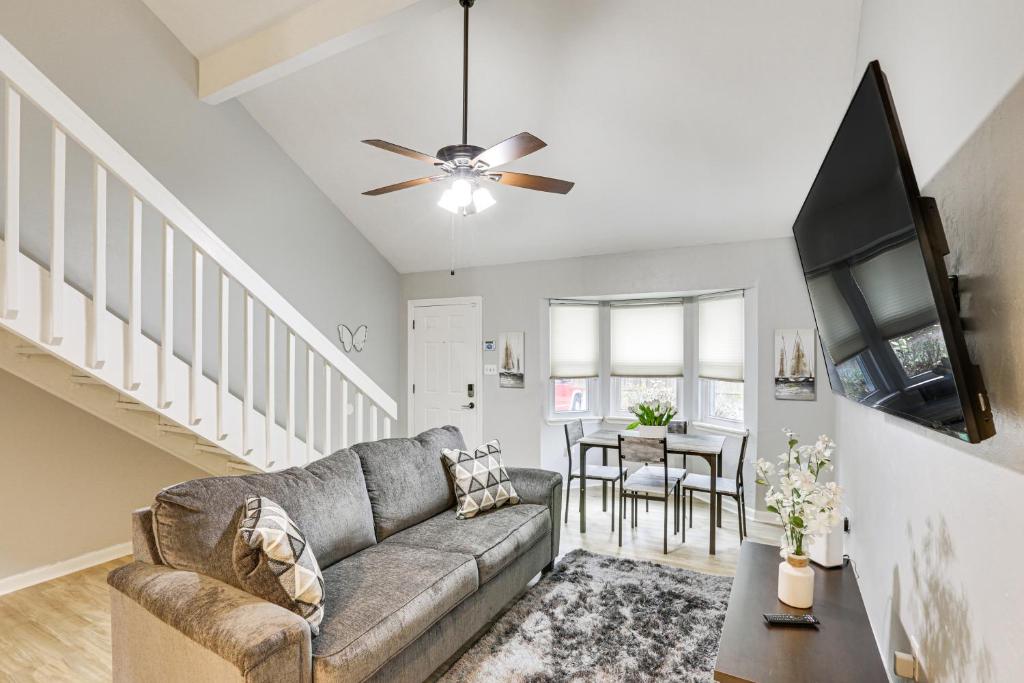 a living room with a couch and a ceiling fan at Updated Tallahassee Townhome 3 Mi to Downtown! in Tallahassee