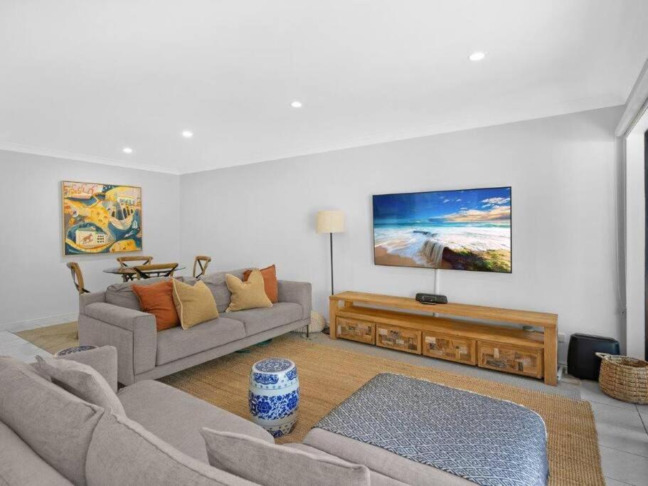 a living room with two couches and a tv at Gold Coast best holiday resort, perfect location ! in Gold Coast