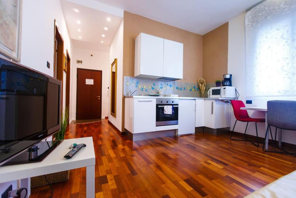 a kitchen with a living room with a table and a kitchen at Venice-Flat 75m² perfect for 2 couples (free Park) in Mestre