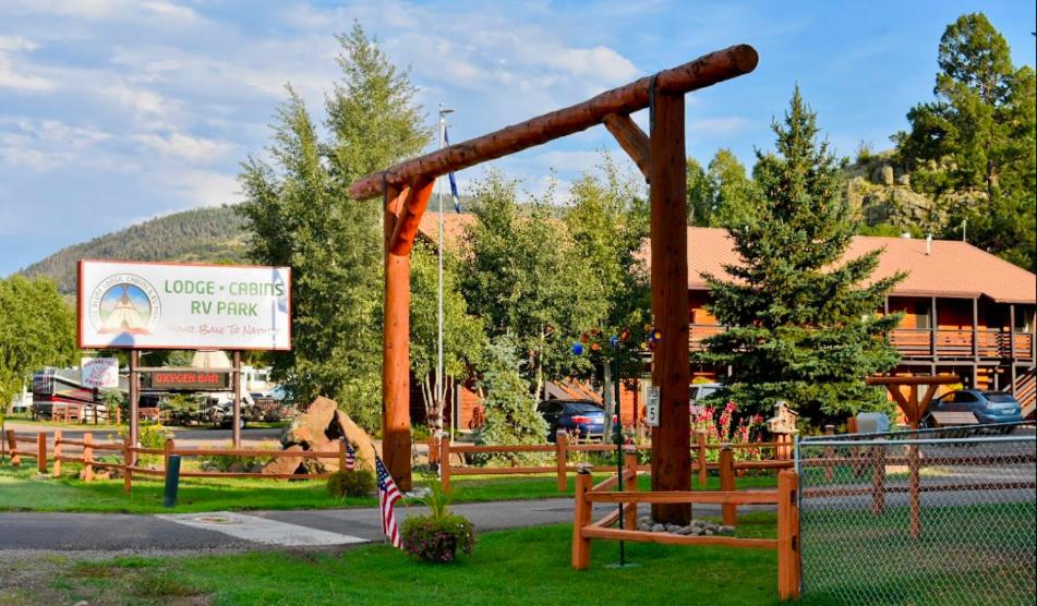 a park with a swing in front of a building at Ute Bluff Lodge, Cabins and RV park in South Fork