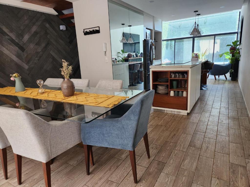 ein Esszimmer mit einem Tisch und Stühlen sowie eine Küche in der Unterkunft Cozy room in big Apartmet in Mexiko-Stadt