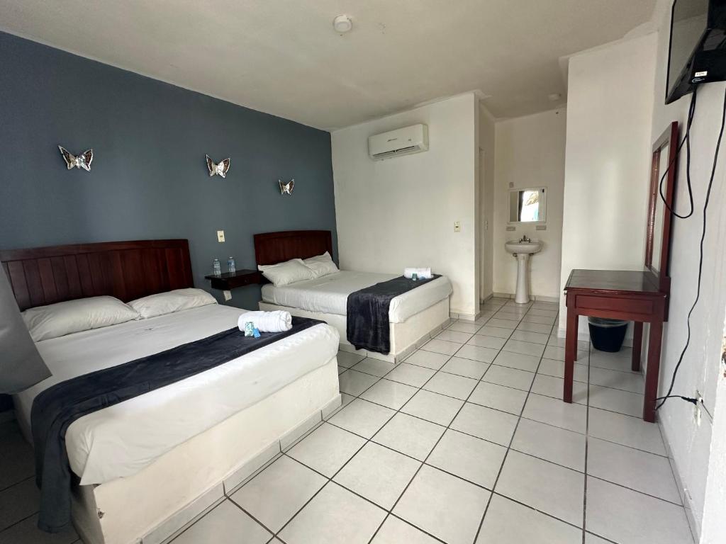 Postel nebo postele na pokoji v ubytování Hotel Grand Bahía Los Cocos