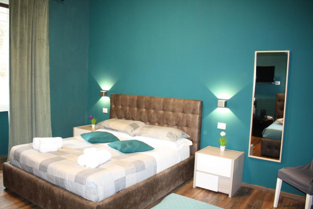 a bedroom with a large bed with blue walls at My Rhome Prati in Rome