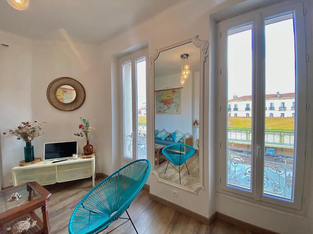 a living room with blue chairs and a mirror at CASA BLUE sur une jolie place proche du vieux port by LaConciergerie13 in La Ciotat